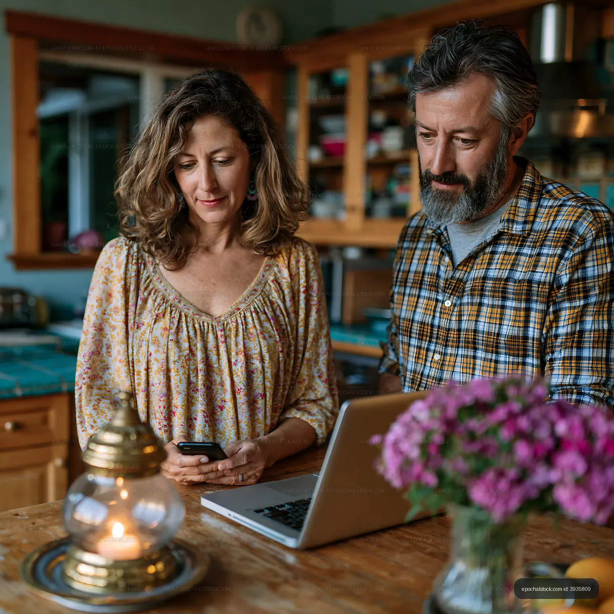 Couple working together in a kitchen at home in the evening