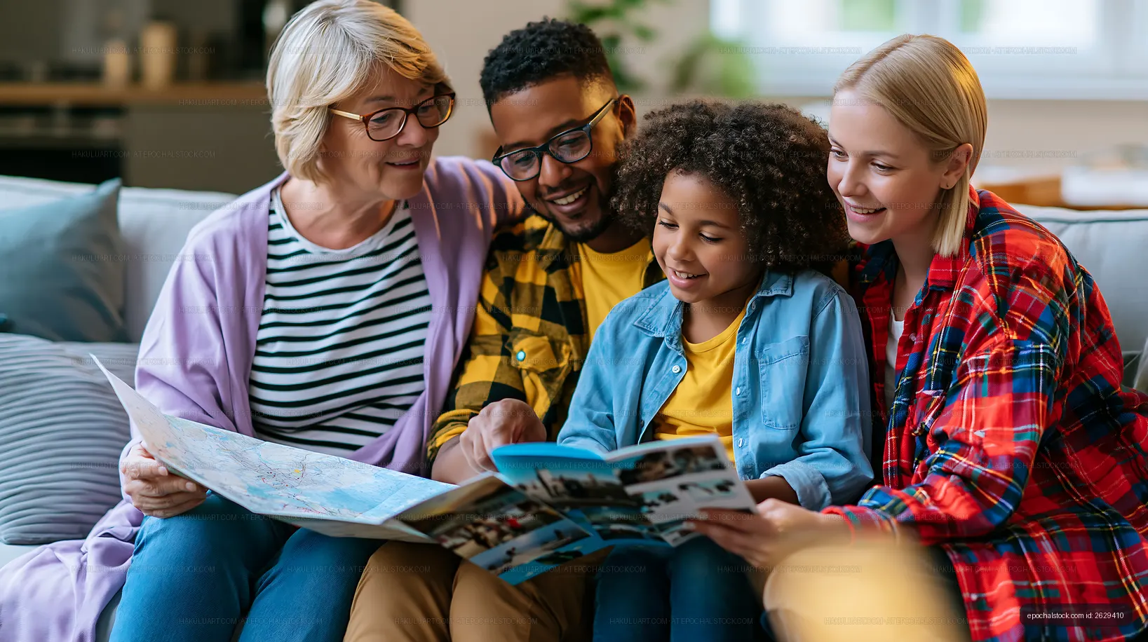 Family enjoying time together reading a travel guide at home