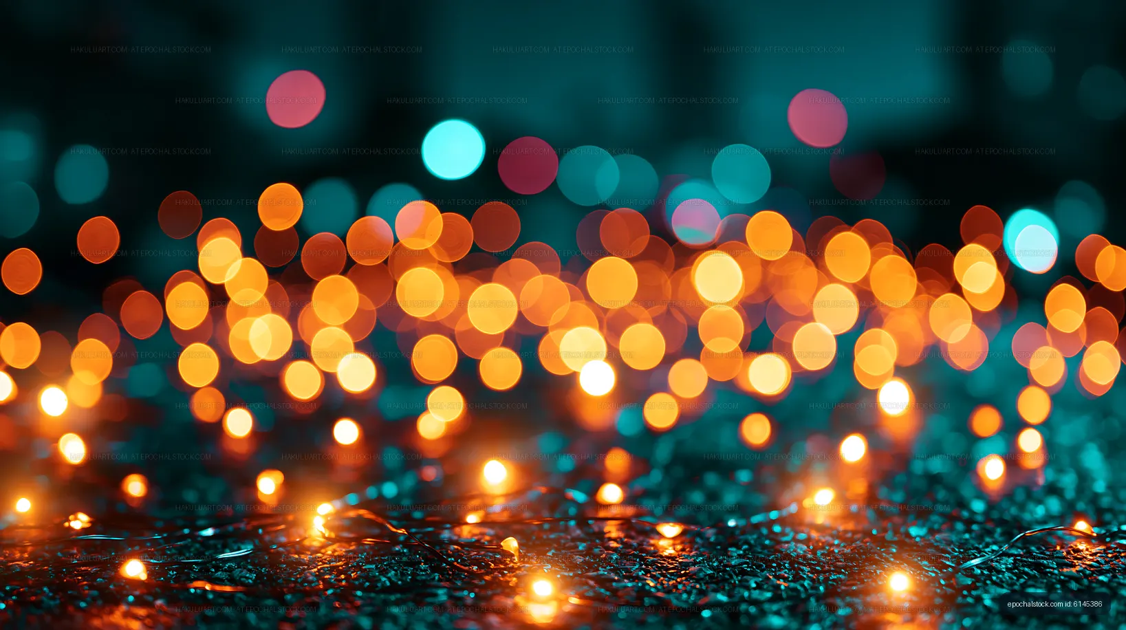 Warm orange and blue bokeh lights on a dark surface
