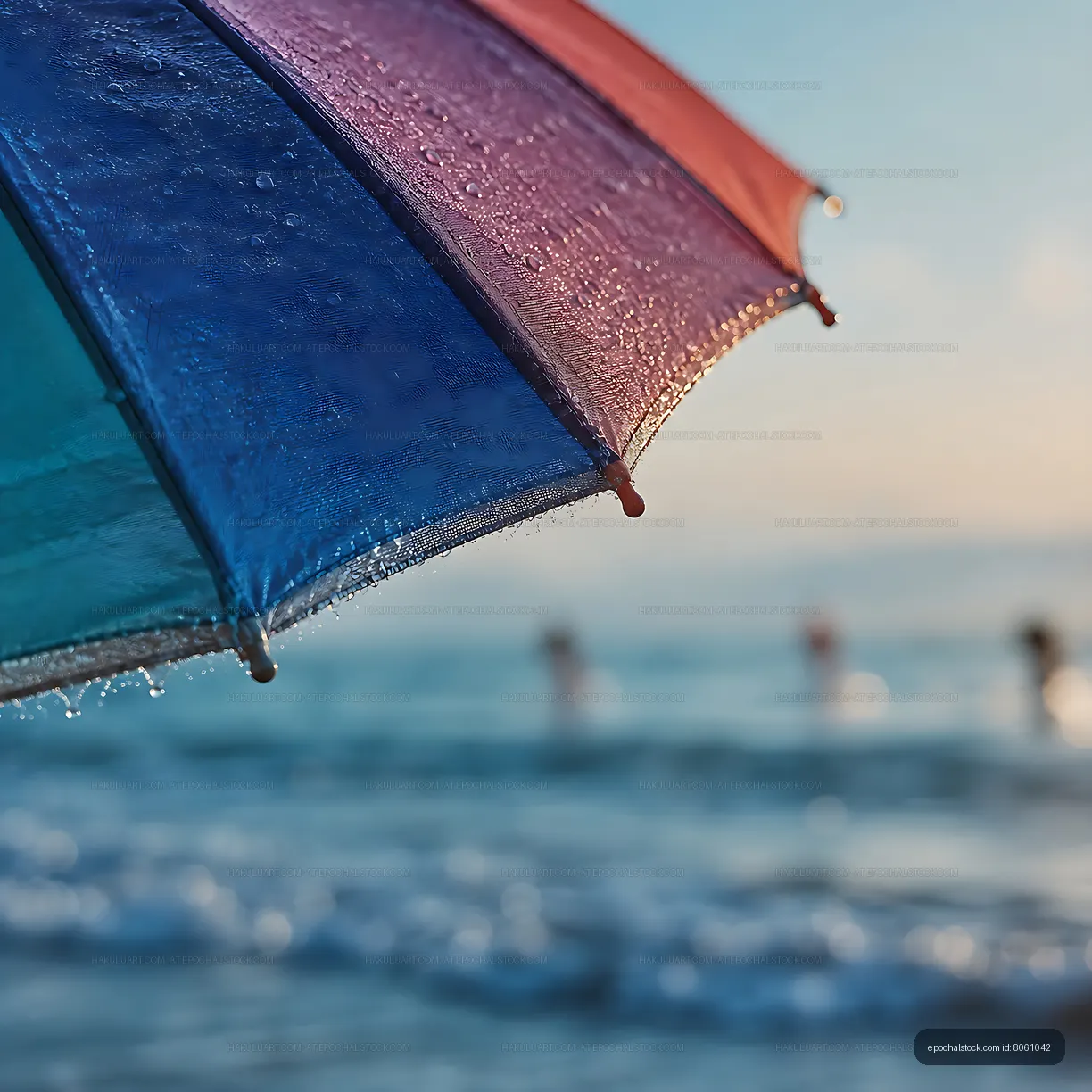 Colorful umbrella over ocean waves on a sunny day