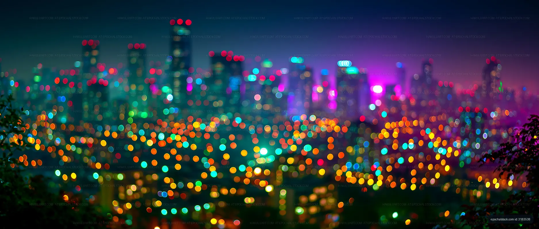 Colorful city lights at night with a blurred skyline