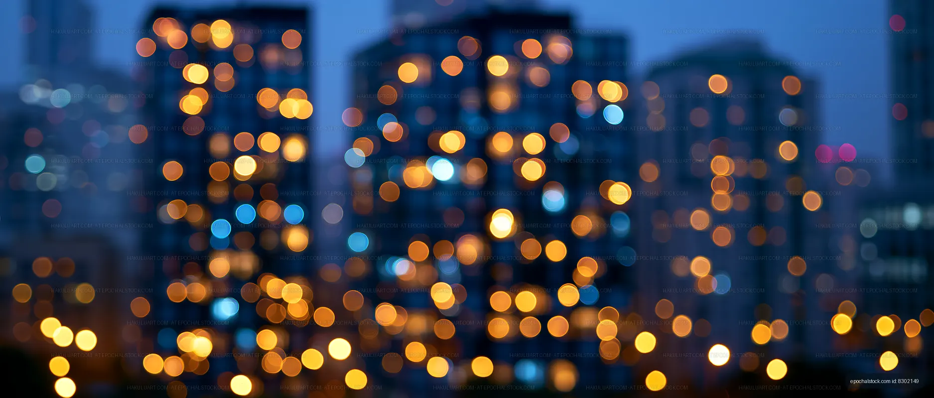 City lights at night with blurred focus from high-rise buildings