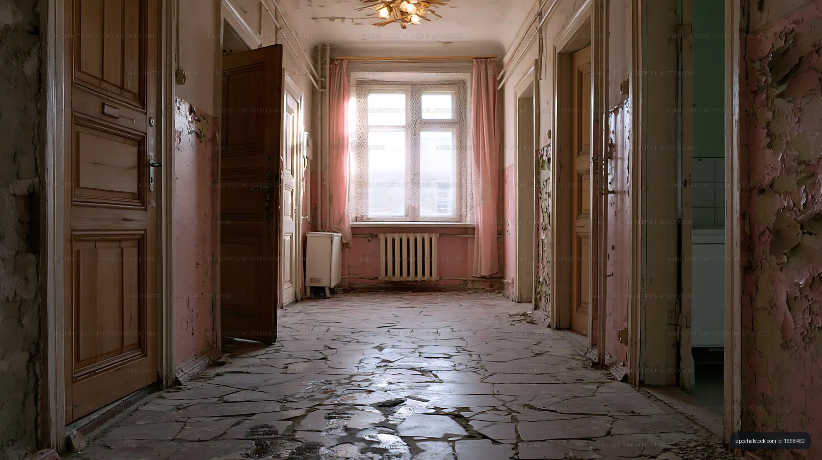 Abandoned hallway with cracked floor and peeling walls