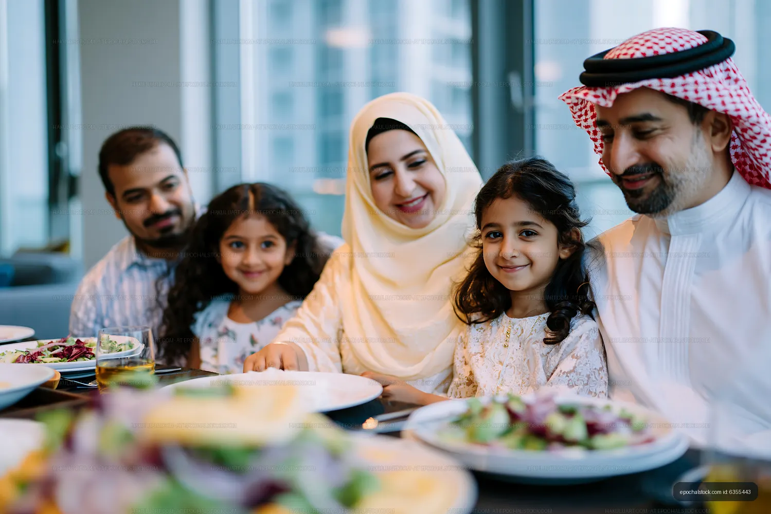 Family gathering around a table in modern dining room