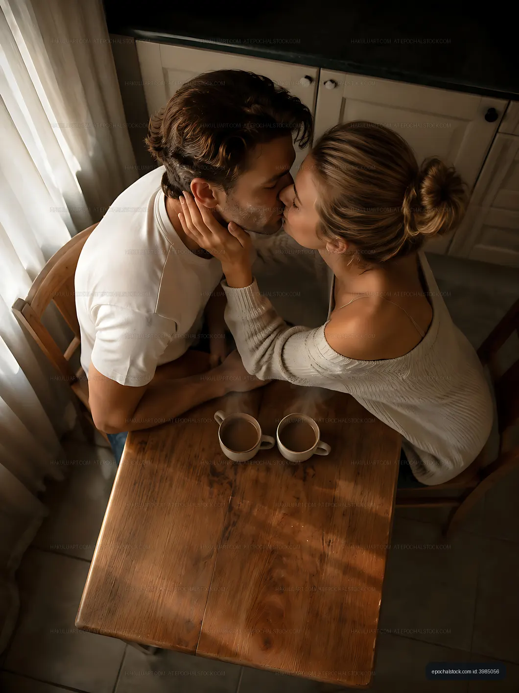 Couple sharing a kiss at a wooden table with coffee cups