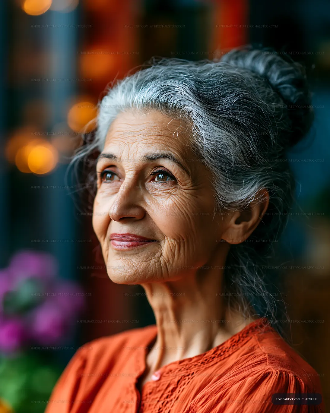 Elderly woman with gray hair smiling at home with warm lights