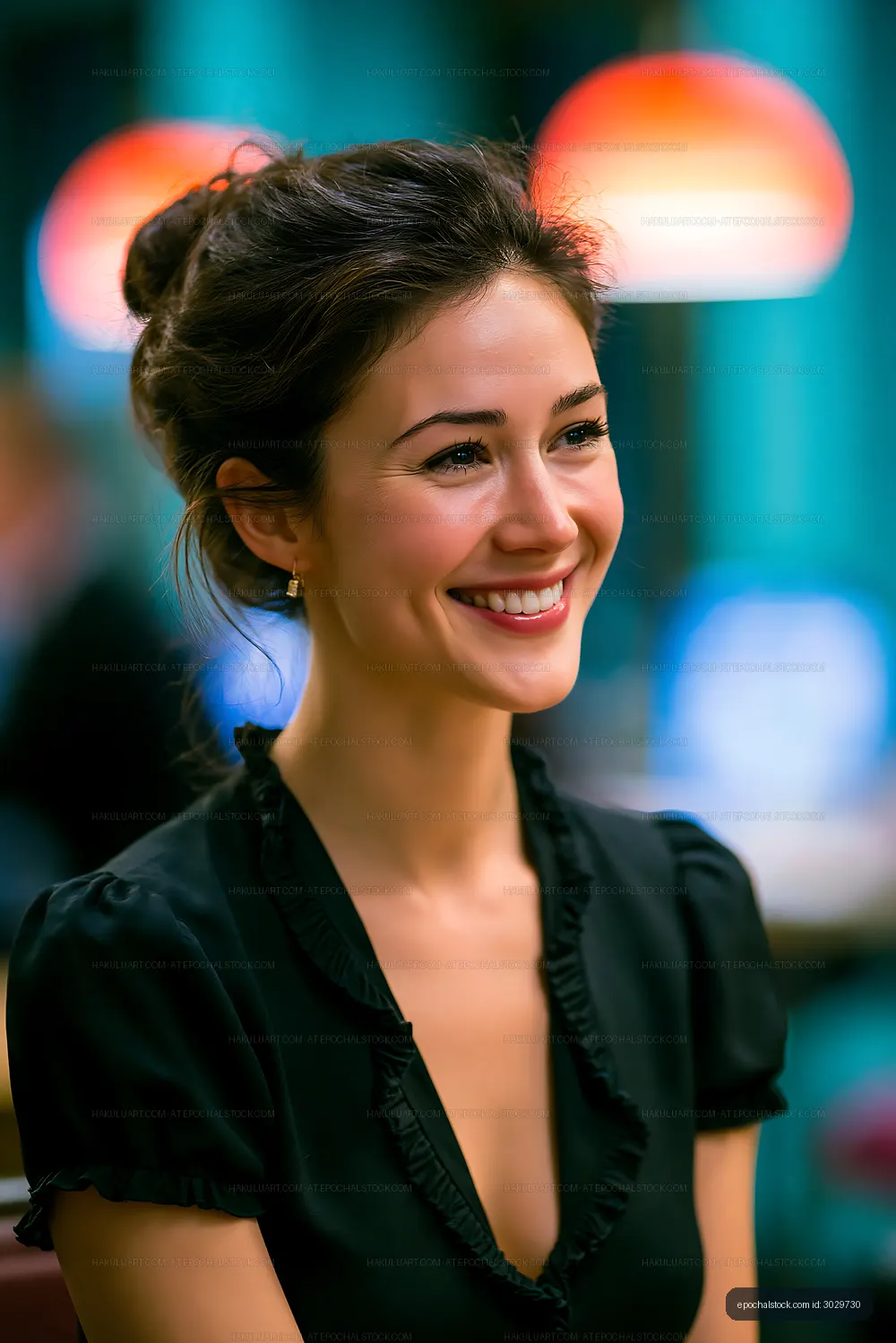 Young woman smiling in a cafe with colorful lighting