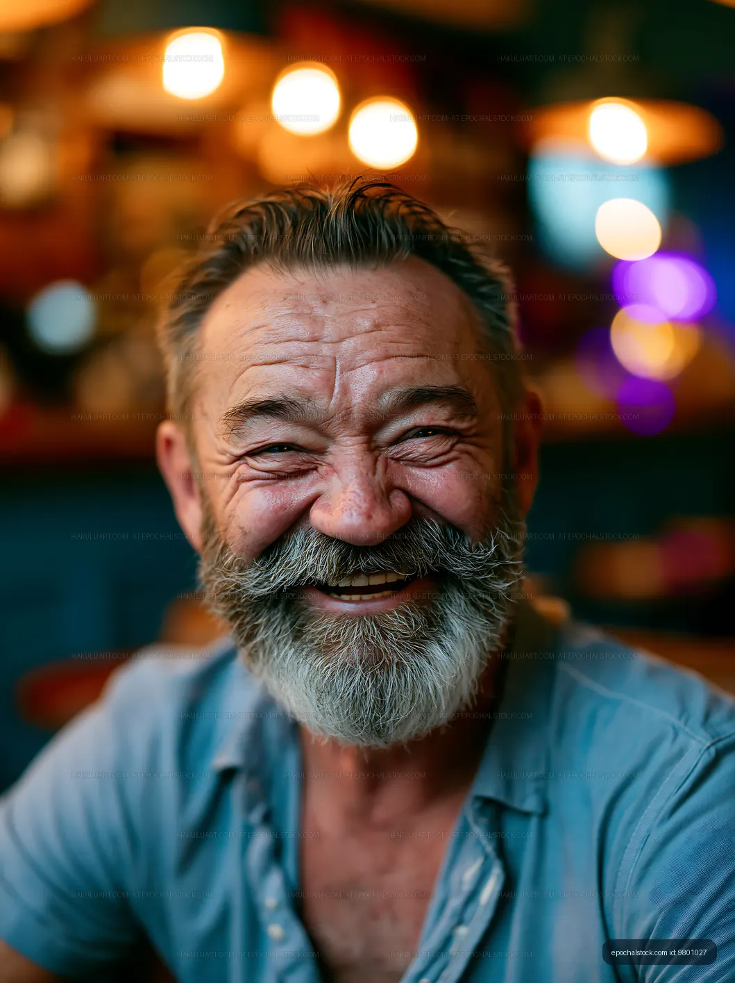 Smiling elderly man with a beard at a cafe in the evening
