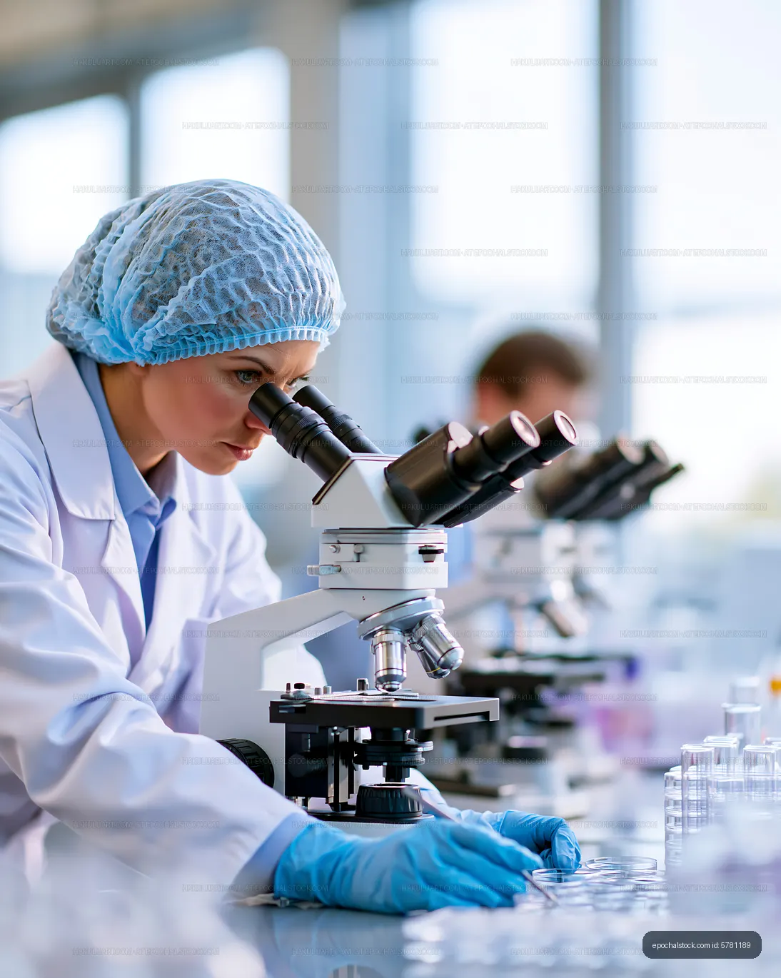 Scientist working at a laboratory with a microscope