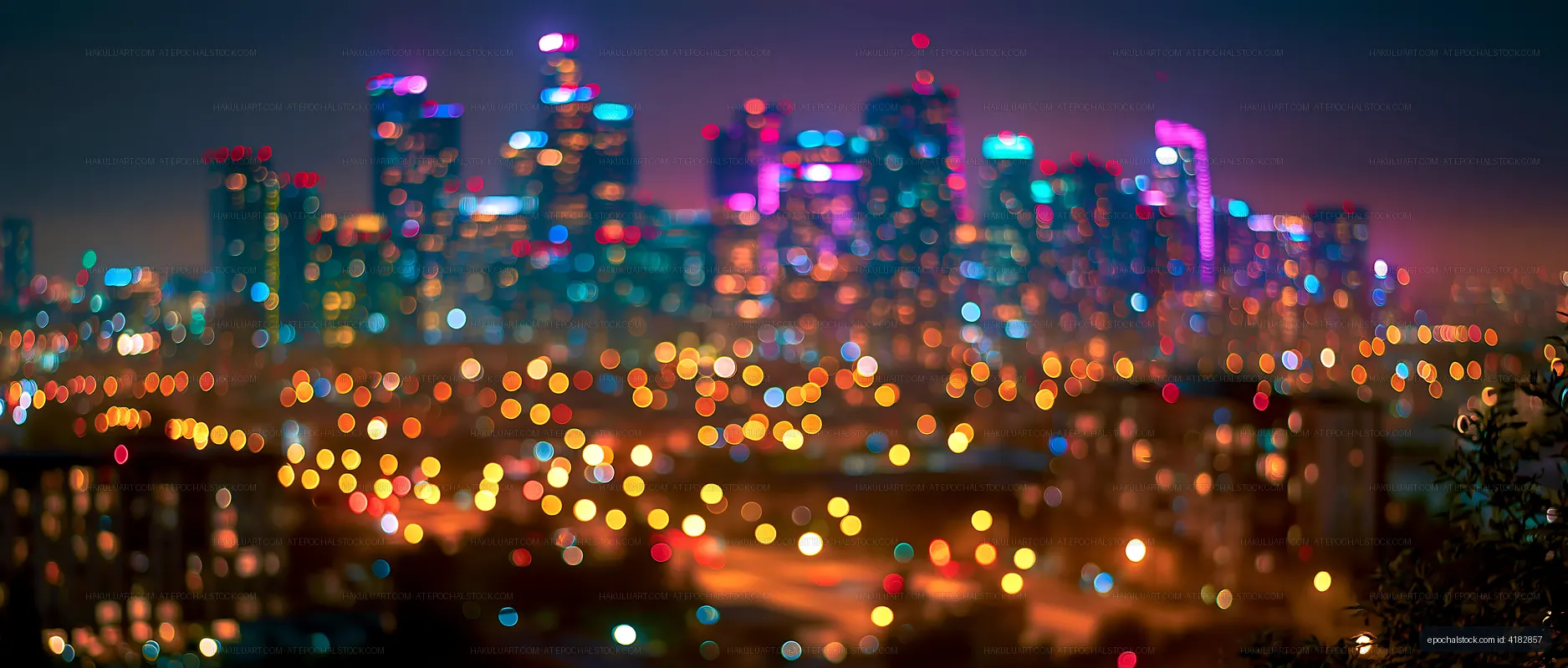City skyline at night with colorful lights and blurred background