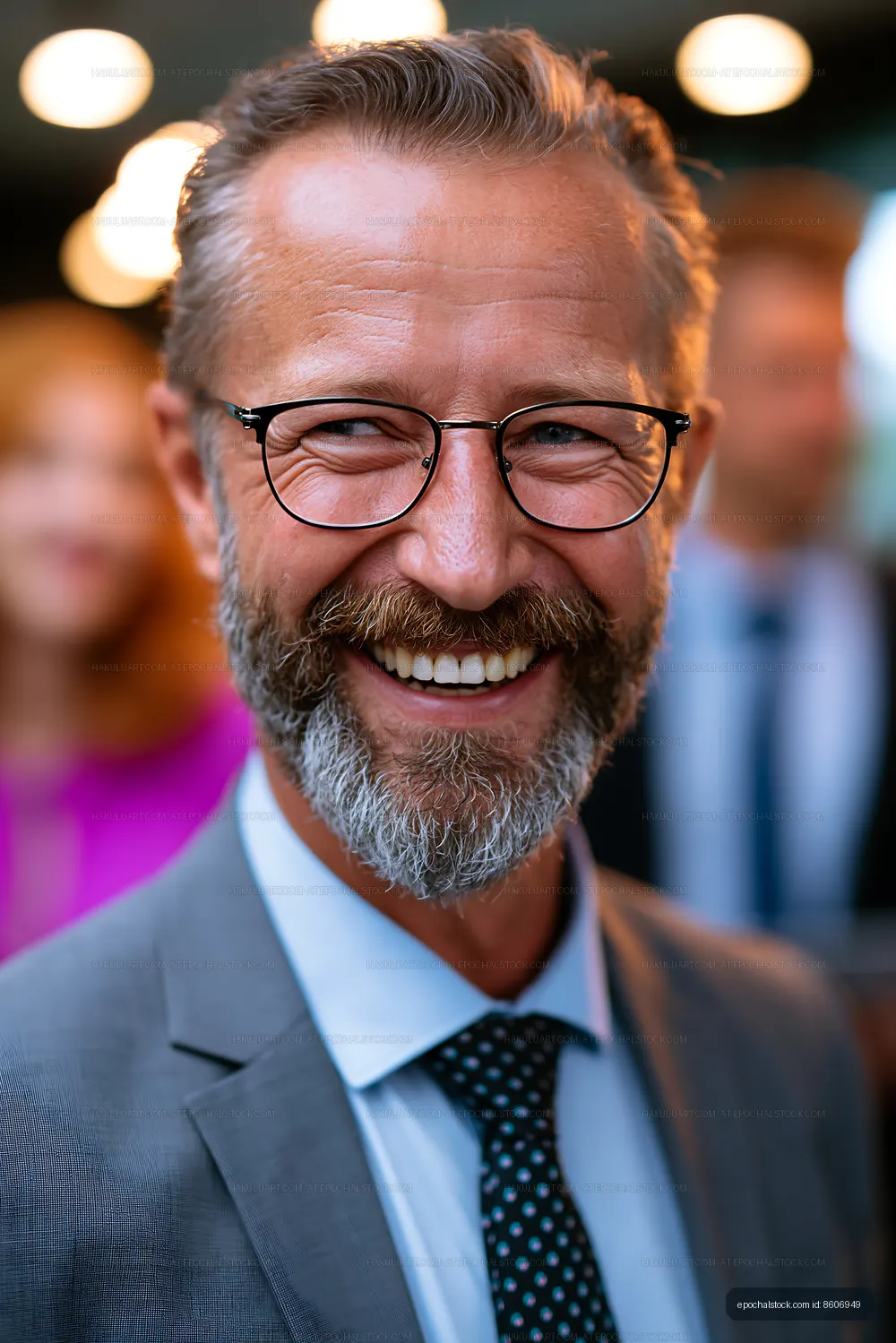 Smiling man with glasses in a business suit at an event