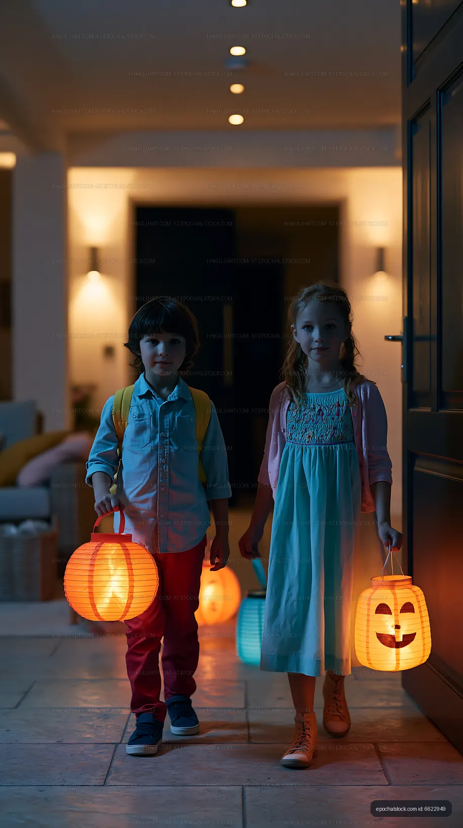 Children walking indoors with lanterns during Halloween
