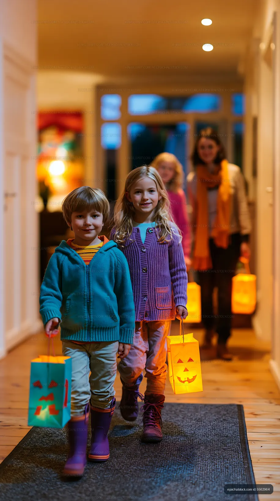 Children carrying Halloween lanterns in a home hallway