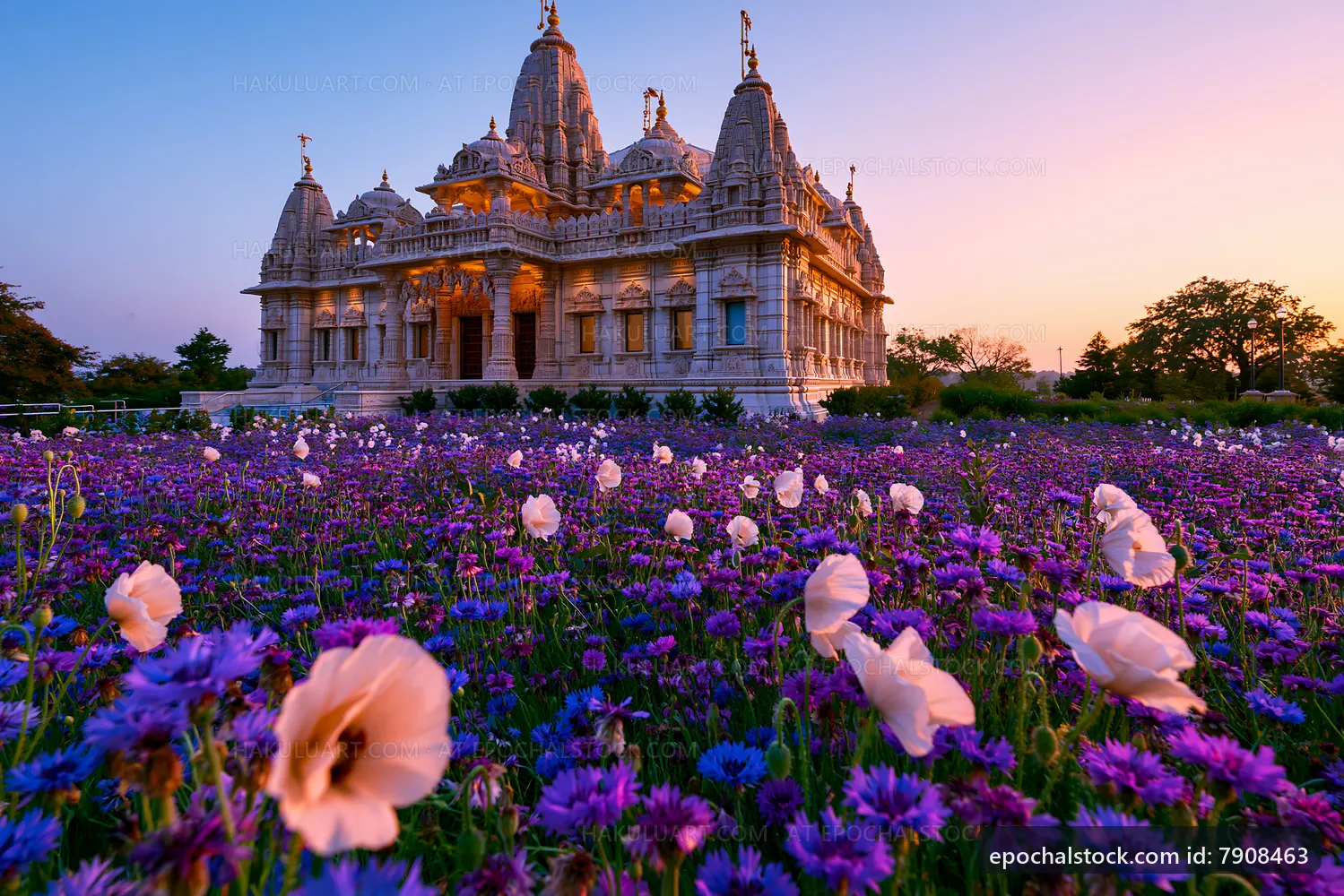 Beautiful temple surrounded by vibrant flowers during sunset