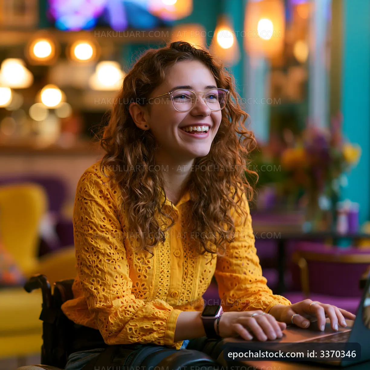 Young woman smiling while working on laptop in colorful cafe
