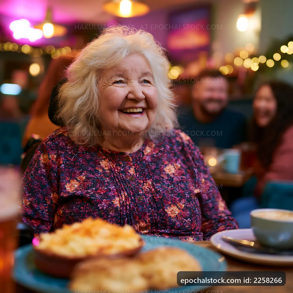 Smiling elderly woman enjoying a meal with friends at a cafe