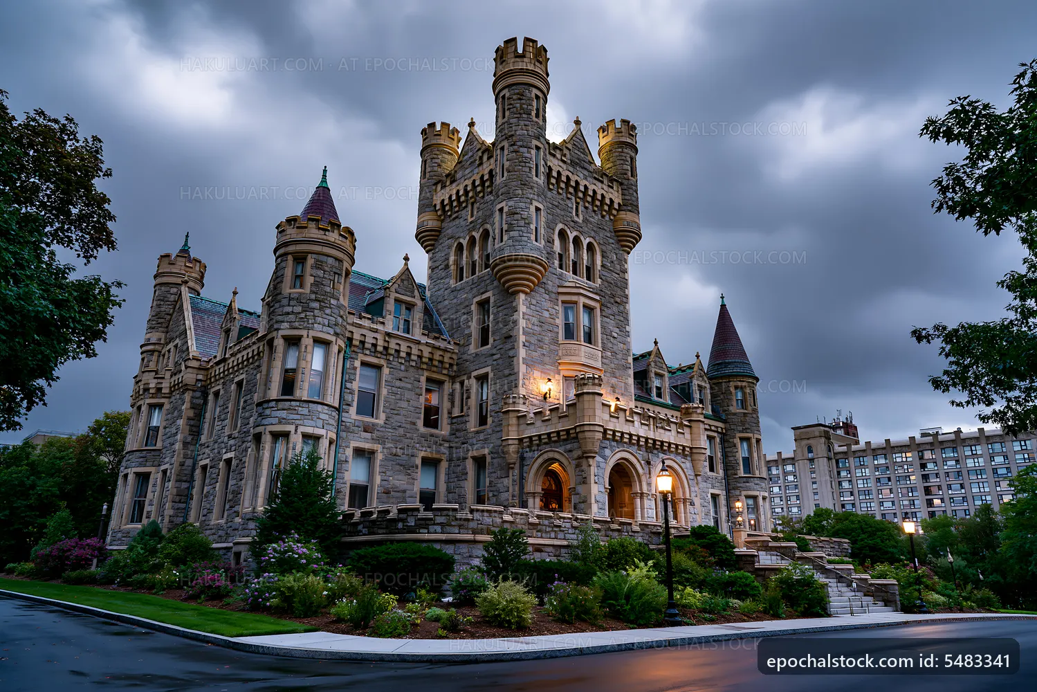 Historic stone castle under cloudy sky at dusk