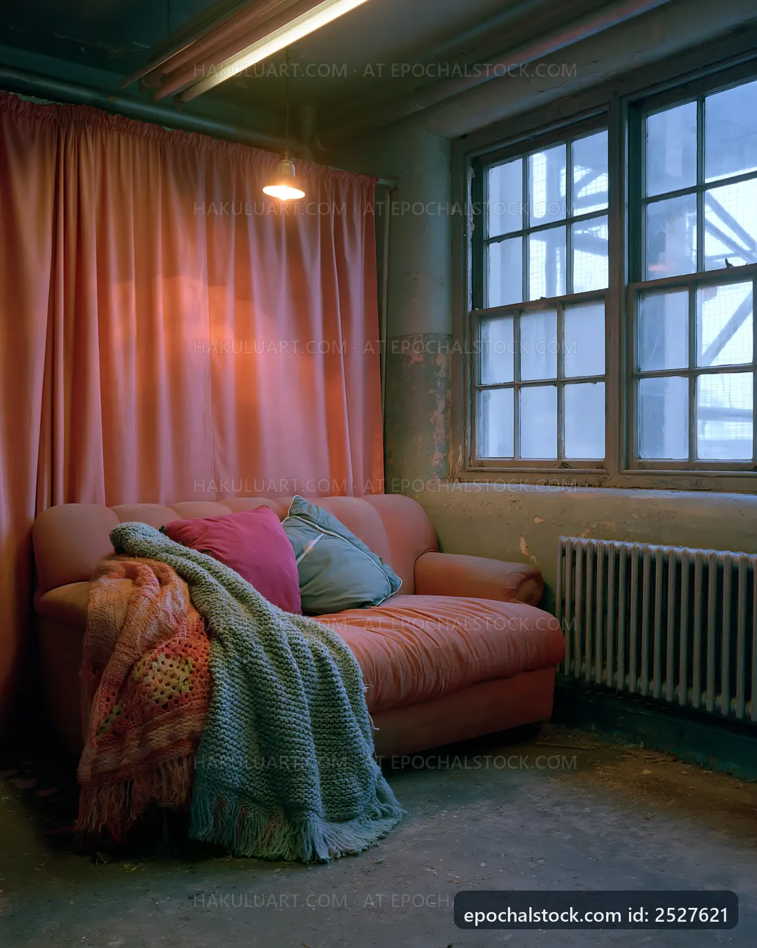 Cozy living space with a couch and window in an industrial setting