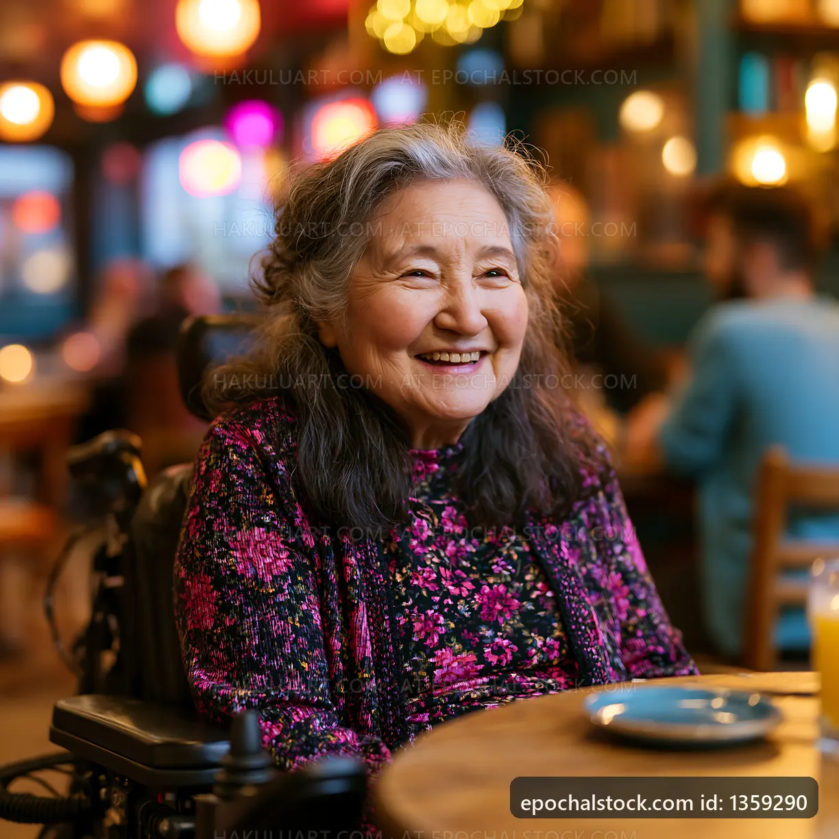 Smiling woman in a wheelchair at a cafe with warm lighting