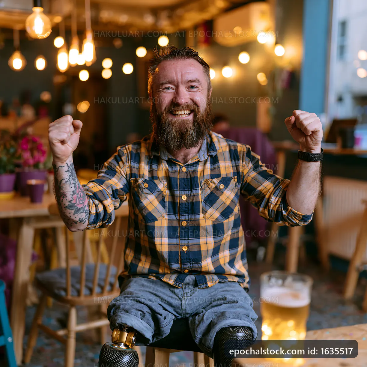 Man celebrating at a pub with prosthetic legs and a beer