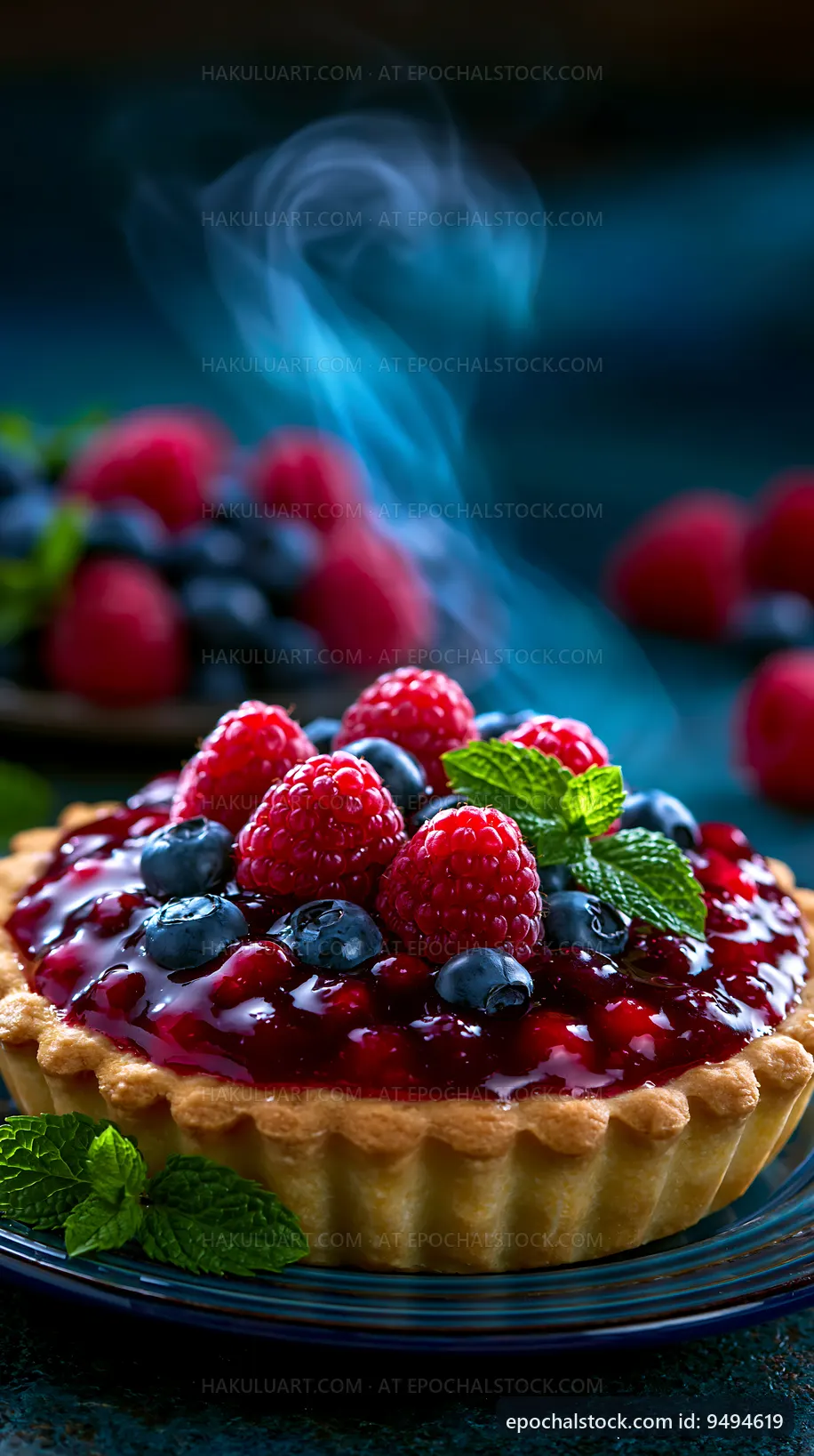 Fresh fruit tart with berries and mint leaves on a blue background