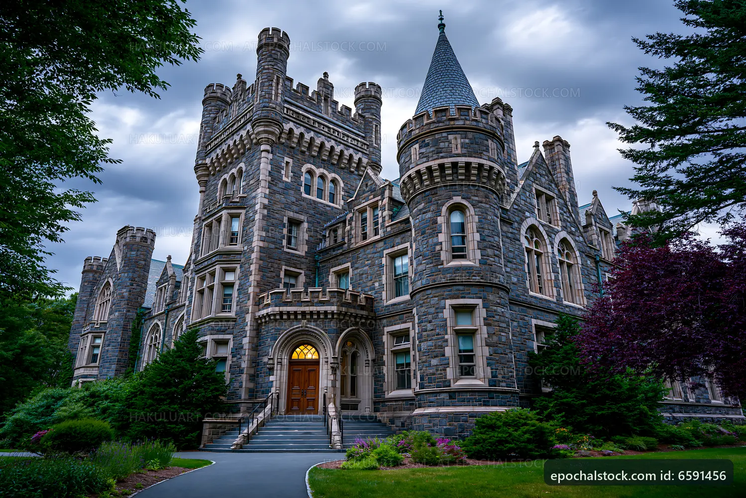 Historic stone castle with towers and lush greenery outside