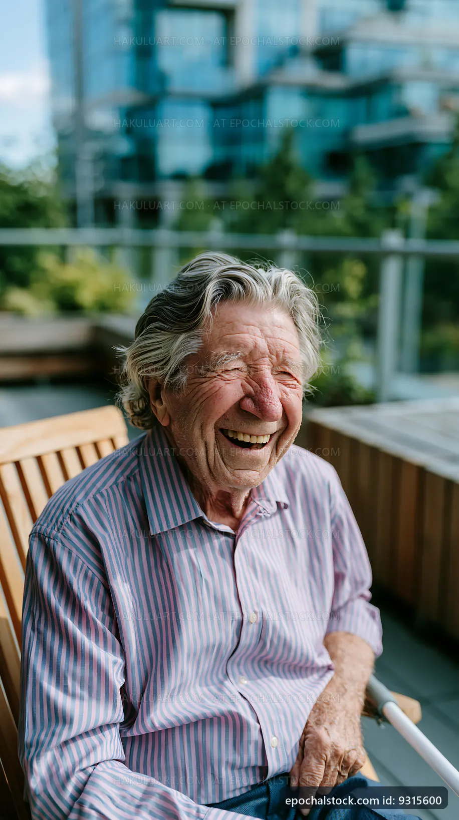 Elderly man laughing on a wooden bench outdoors