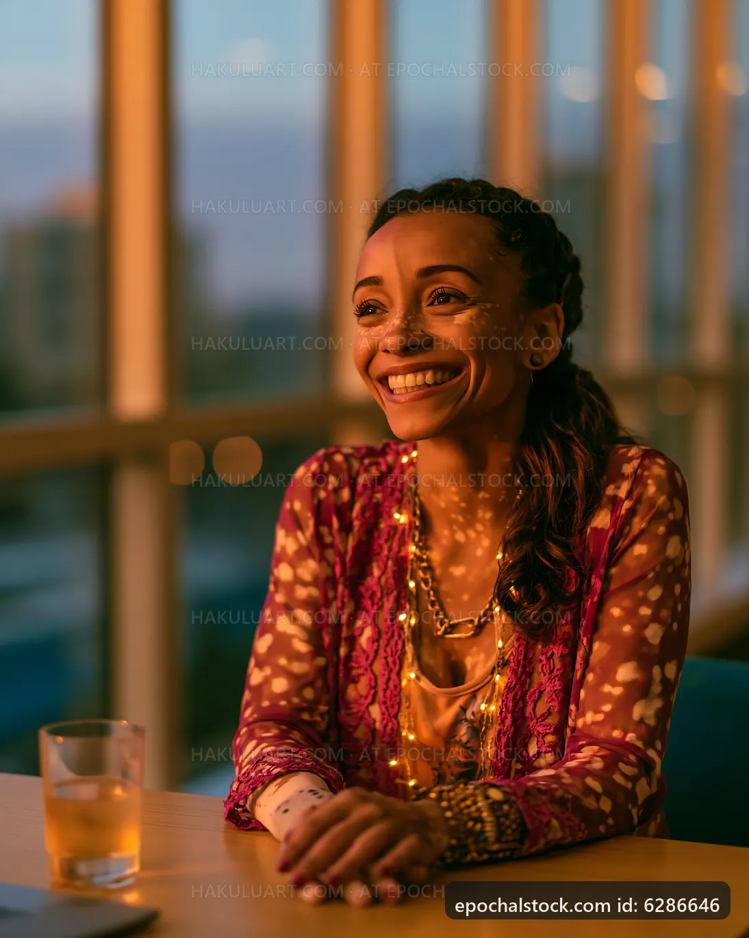 Woman smiling in bright indoor setting with evening light