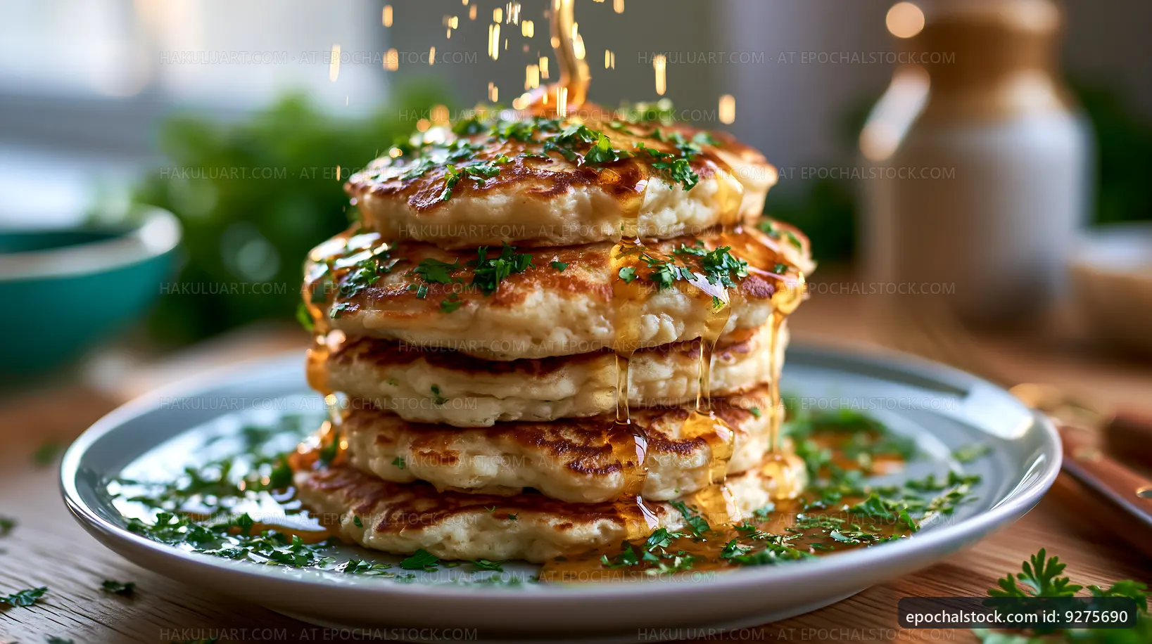 Stack of pancakes topped with herbs and syrup on a plate
