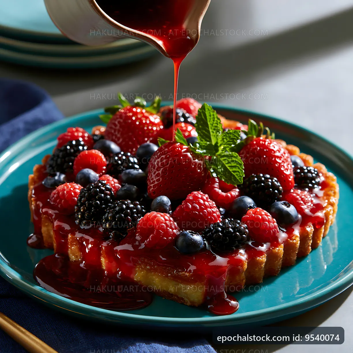 Berry tart with red sauce on a blue plate