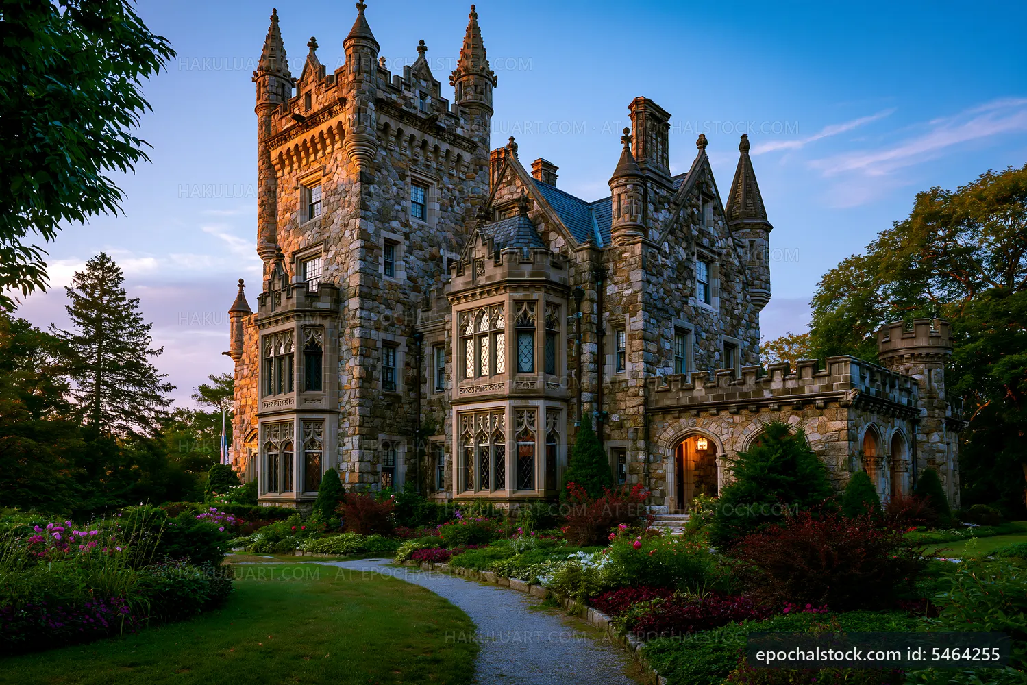 Historic stone castle surrounded by gardens at sunset