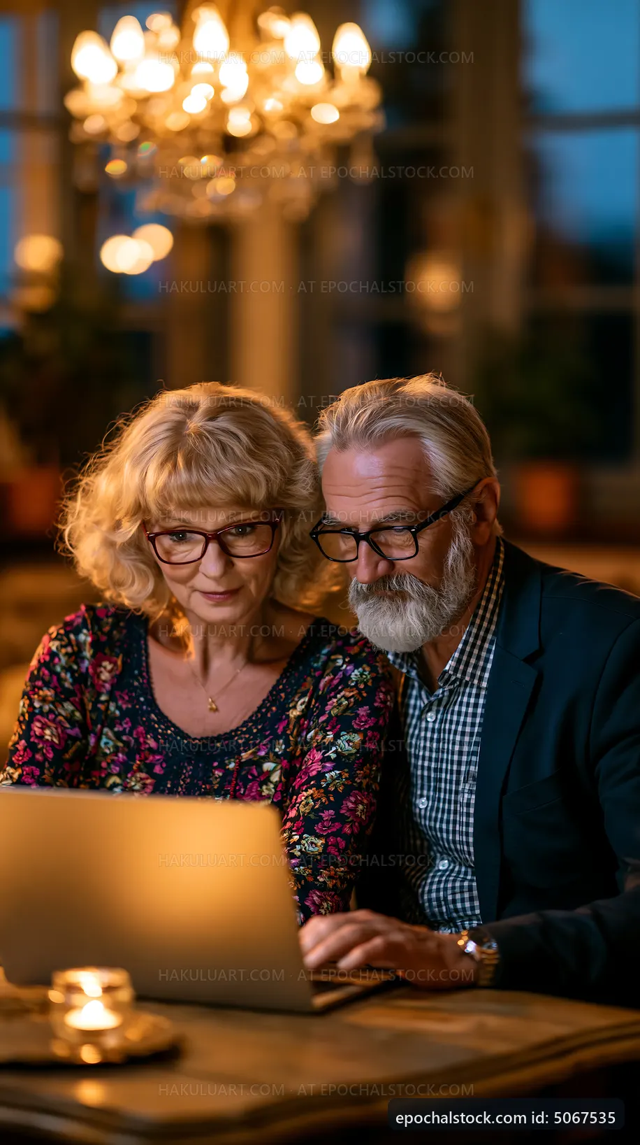 Older couple using laptop together in cozy setting