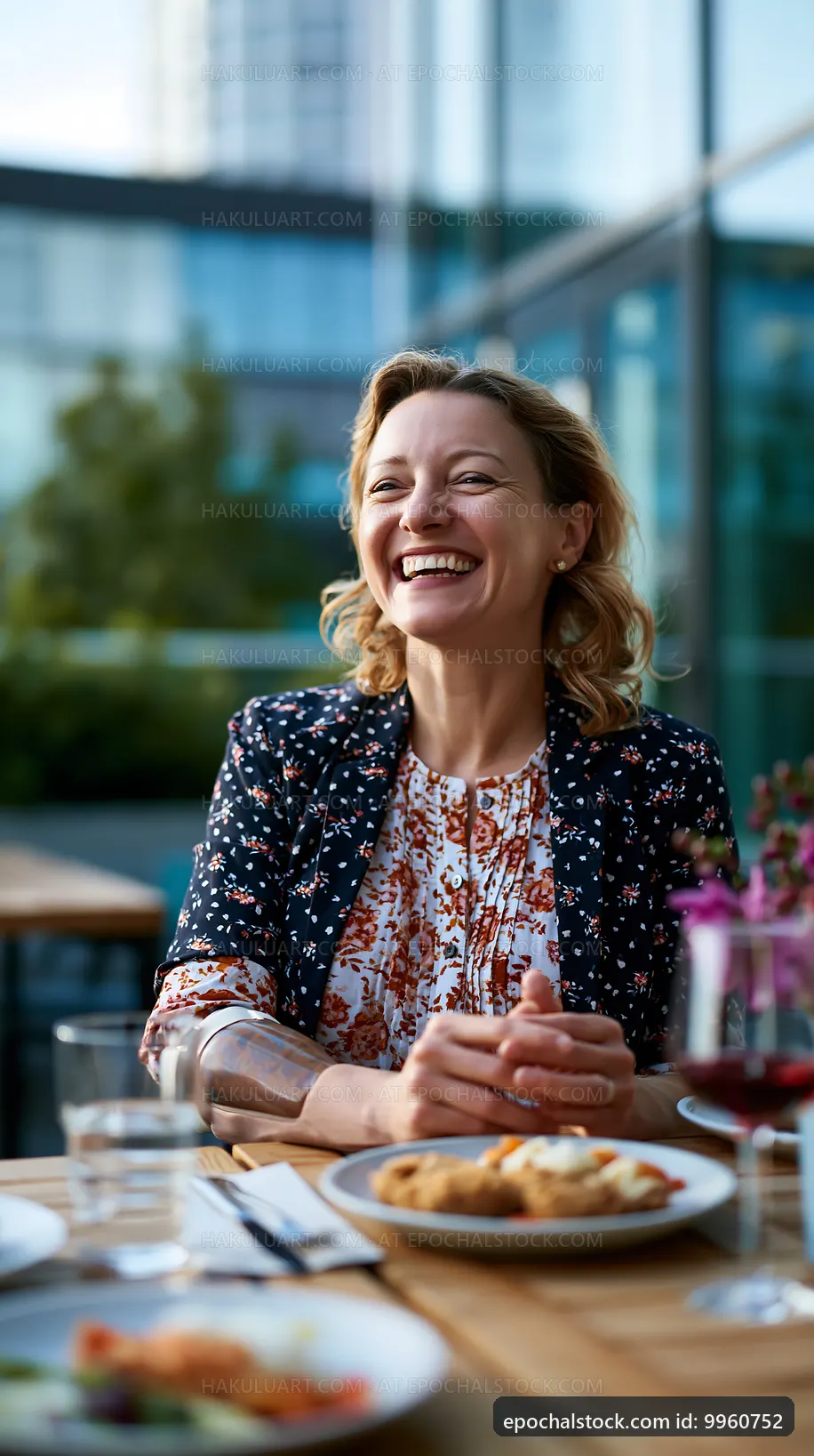 Woman smiling at a table in a restaurant during the day