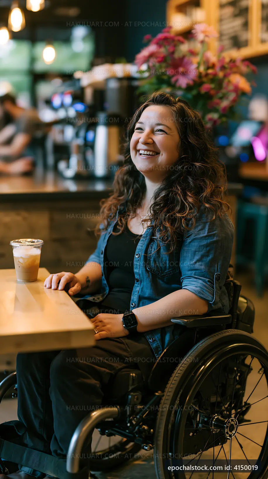 Woman in wheelchair enjoying drink at a cafe