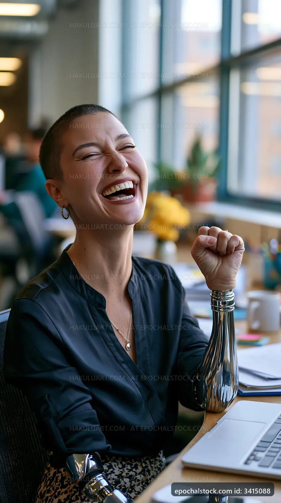 Woman laughing in an office with prosthetic arms