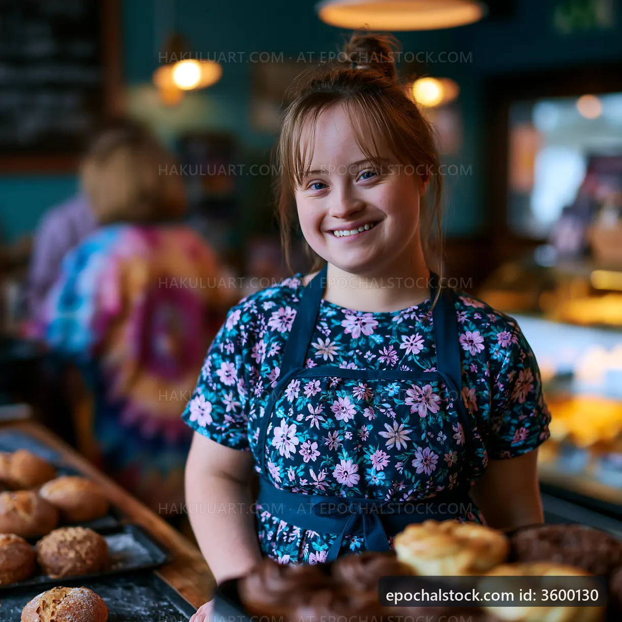 Child holding baked goods in a bakery