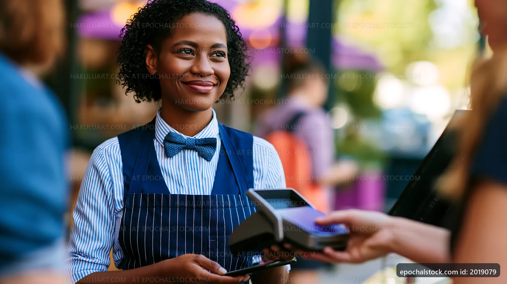 Server assisting customers at café with payment process