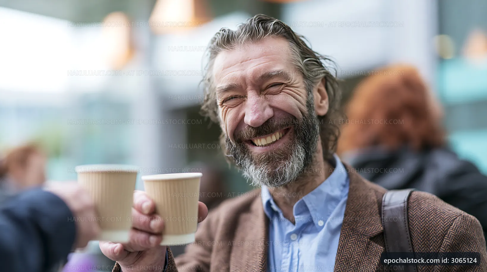 Man smiles and raises cup in outdoor cafe