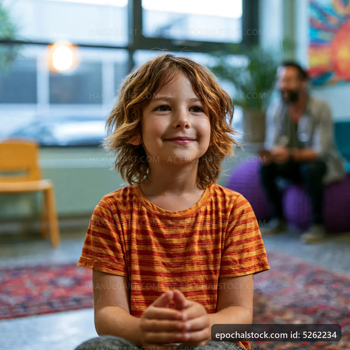 Child smiling in a room with colorful decor and soft lighting