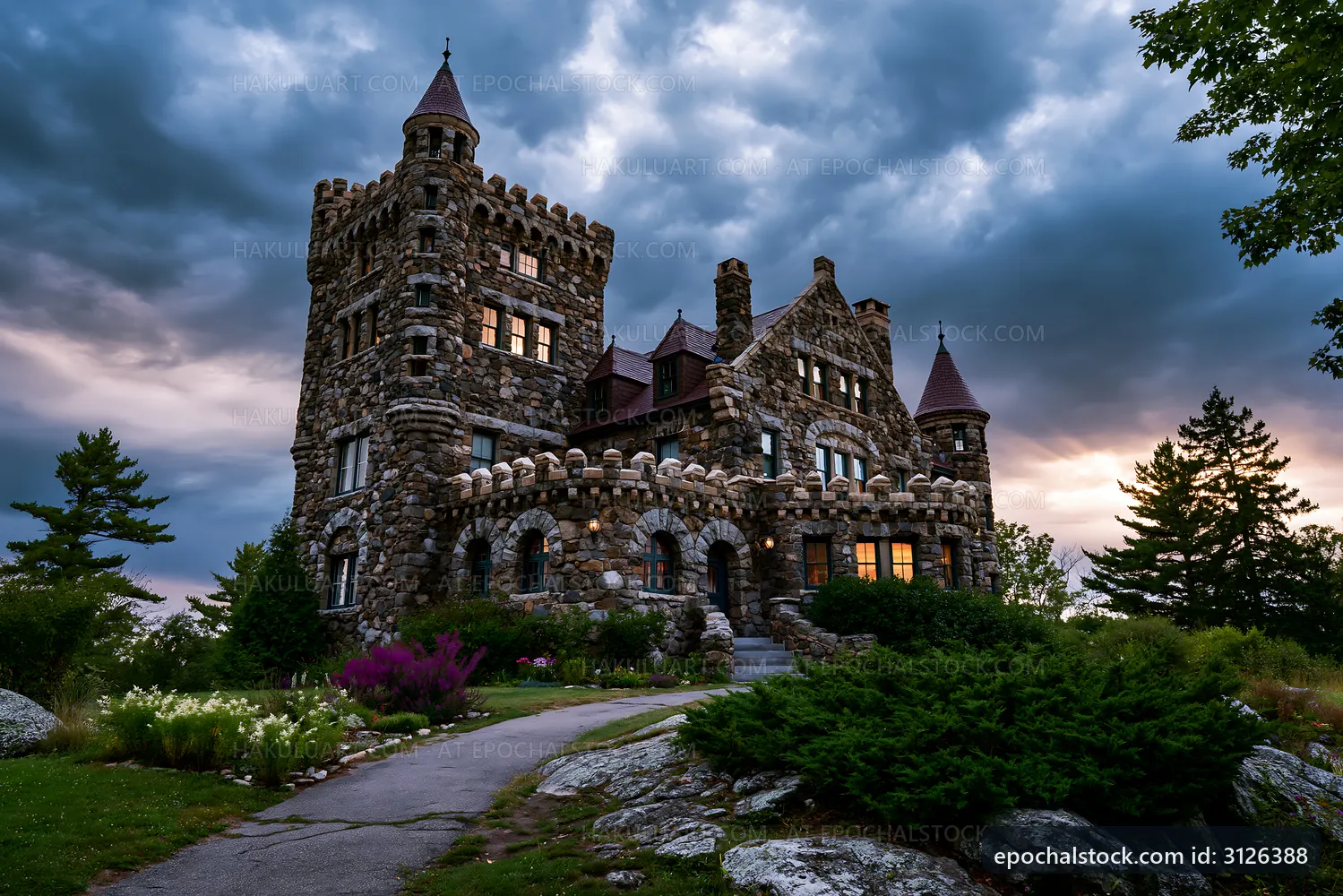 Historic stone castle under a cloudy sky at dusk