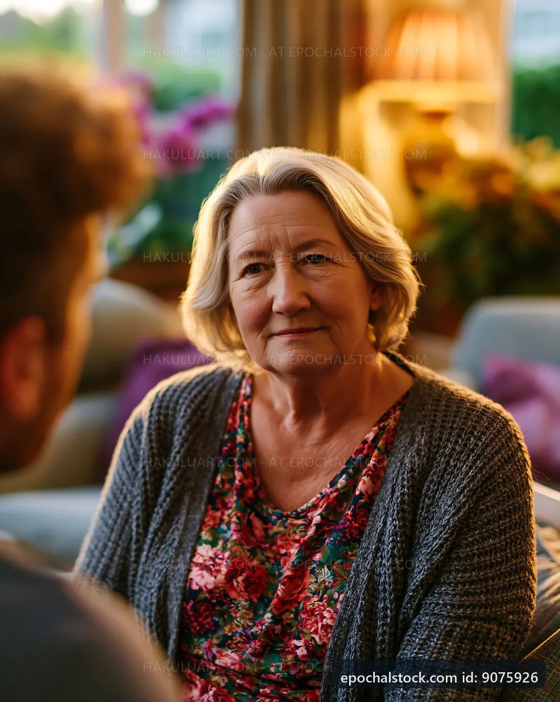 Senior woman listens to conversation in a cozy living room
