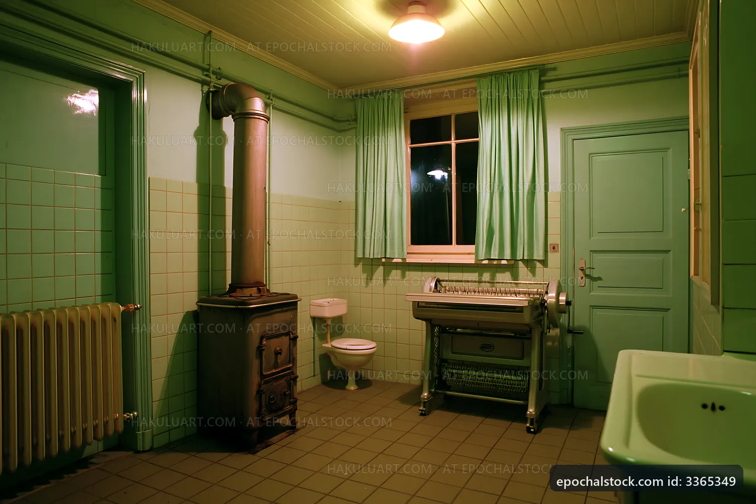 Inside an empty bathroom with green walls and vintage fixtures