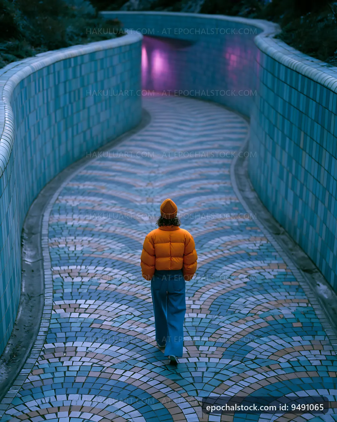 Person walking down a curved path with colorful tiles at dusk