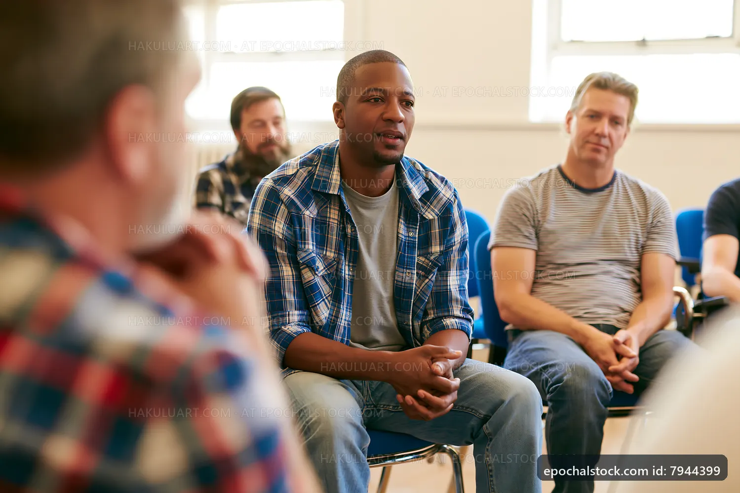 Men participating in a group discussion in a meeting room