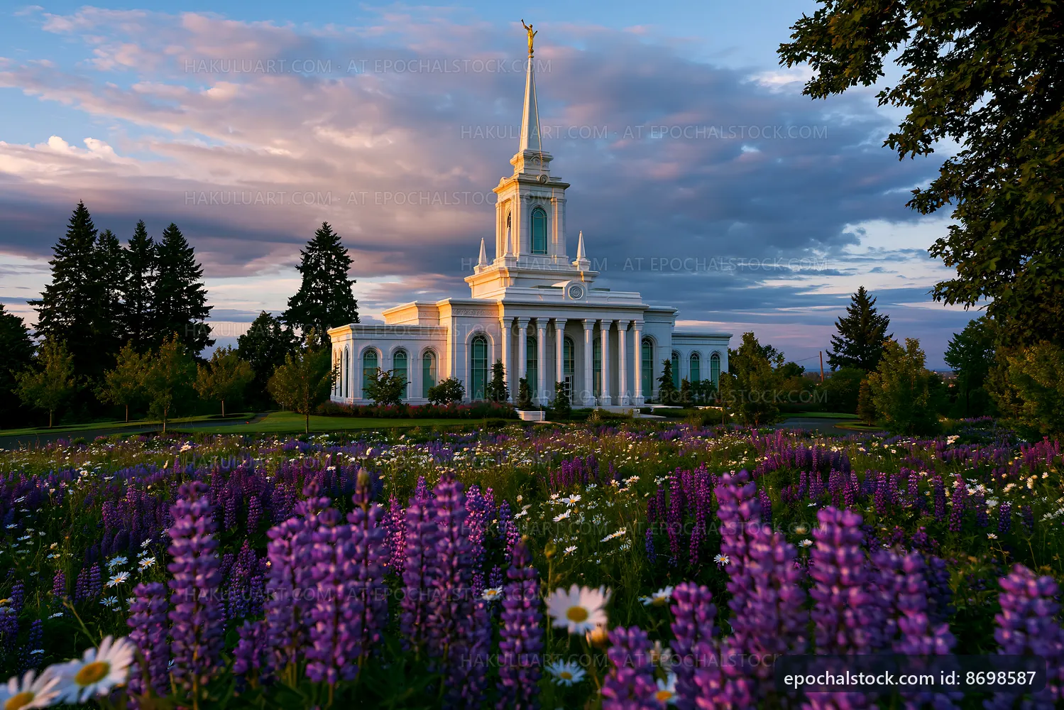 Building with white columns against a sunset and flowers