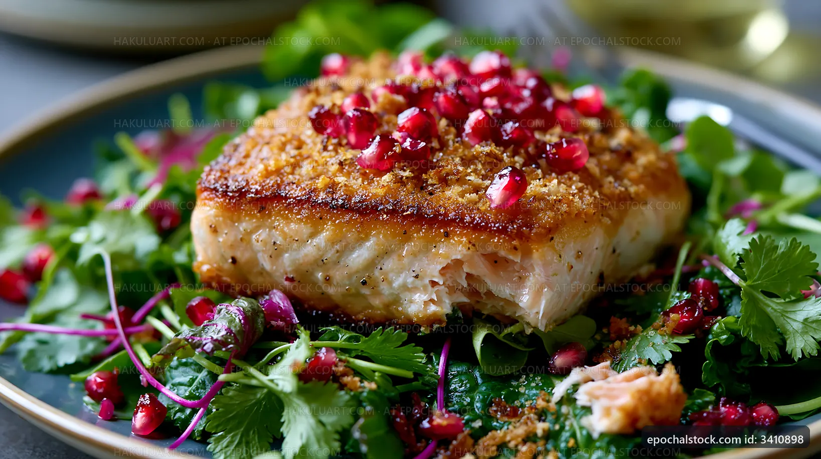 Grilled salmon on a bed of fresh greens with pomegranate