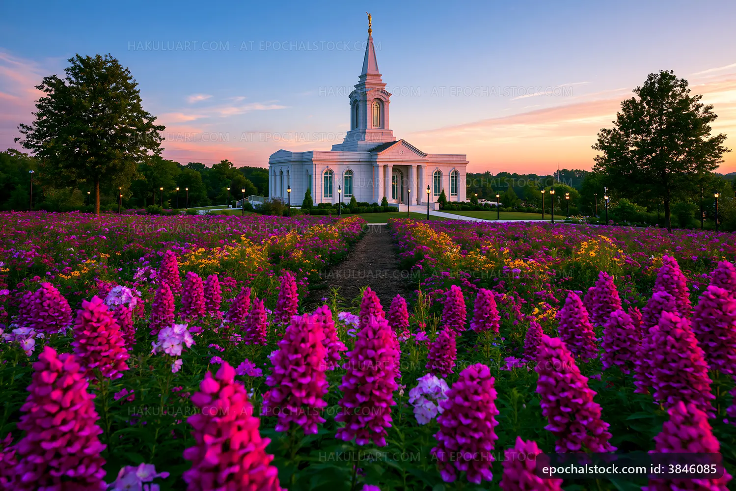 Church surrounded by colorful flowers during sunset