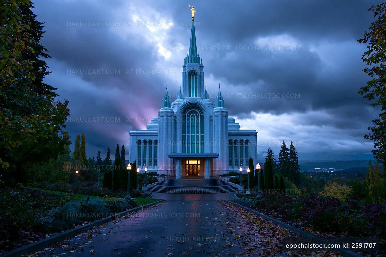 Church building with tall spire against a cloudy sky at dusk