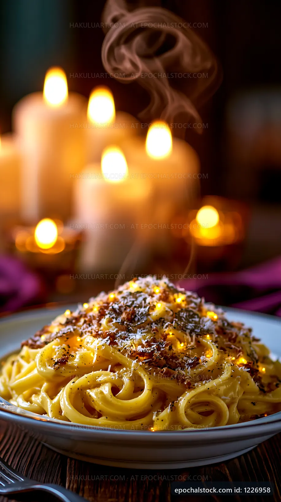 Pasta dish with steam and candles in the background