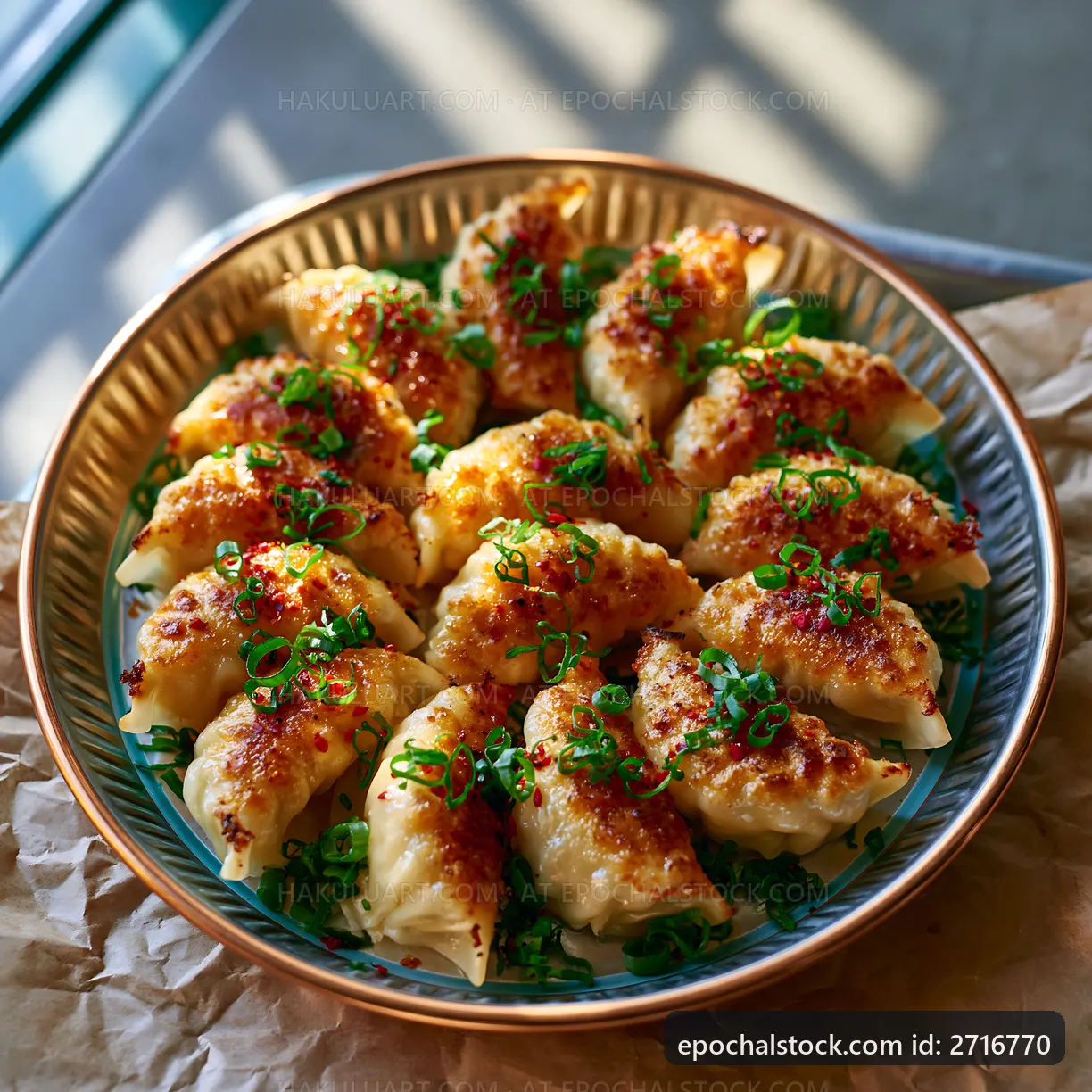 Delicious dumplings served on a plate with green onions